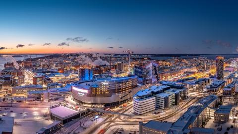 An atmospheric aerial view of Tampere city centre in the evening light. Nokia Arena in the foreground.