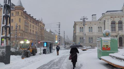 A pedestrian on the Keskustori in a snowstorm.