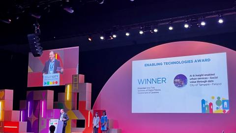 An awards ceremony with people on stage.