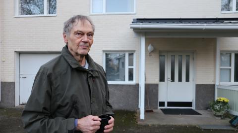 Person in the backyard of a single-family house.