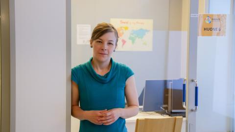 A woman standing on a door.