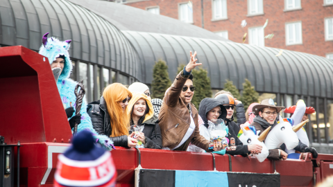 Happy students graduating from high school on the back of a lorry.