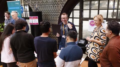 Participants of the English-speaking residents’ evening gathered around a table to discuss with city representatives.