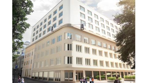 Kuvassa kahden kadun kulmassa vanha rakennus jossa lisäkerroksia.