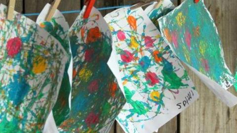 Artworks drying on a clothesline.
