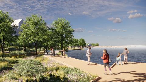 Kuvassa vasemmalla taloja, verhreä ja vihreä kesäinen laituripolku keskellä ja laitureja ja järvinäkymää oikealla.