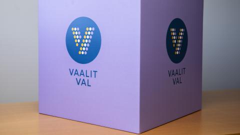 The purple ballot box has the word election written on it.