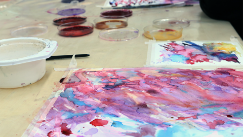 Art project andjars of natural colours on the table.