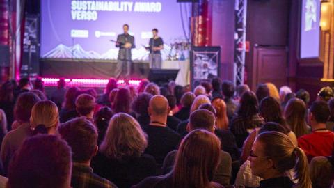 Two performers on stage and an audience.