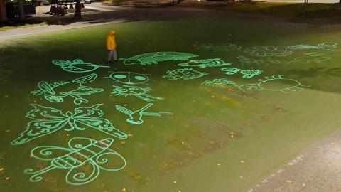 Various bugs on the ground, implemented as a light installation.