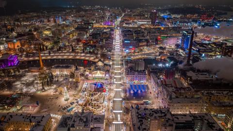 Aerial view of Tampere city centre on a winter night. The lights are shining brightly.