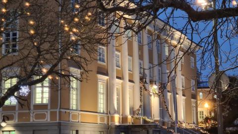 A large yellow building in dim winter lighting.