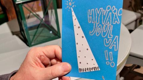 hand holding a Christmas card