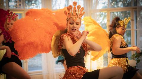 Three samba dancers danced in their colorful costumes.