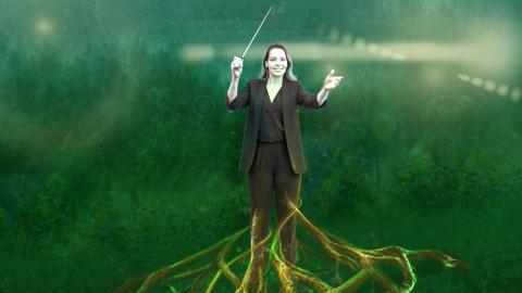 A figure conducts music in a green forest-like setting, with the figure’s legs transforming into branching roots extending into the ground.