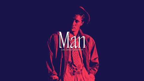 A man in the middle of the picture in red, the background is dark.