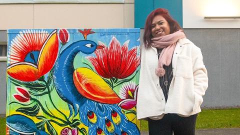 The artist leans against the electrical cabinet they painted in South Hervanta.