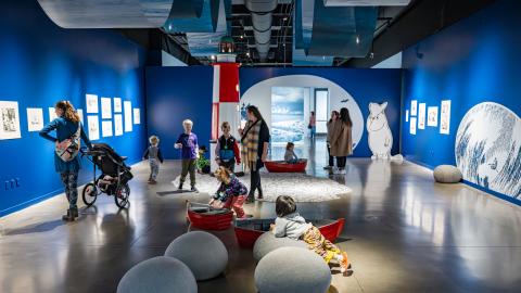 Visitors to the art exhibition are viewing the Moomin artworks. 