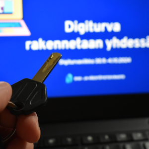 The theme page for Digital Security Week on a computer. In the foreground, there is a key.