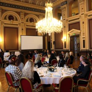 People seated at lunch tables inside Tampere City Hall.