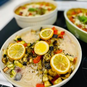 Vegetable-based food served topped with lemon slices.