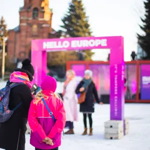 People look at their phones in front of UMK decorations in Sori Square.