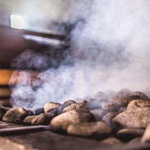 The stones in the sauna stove are steaming.