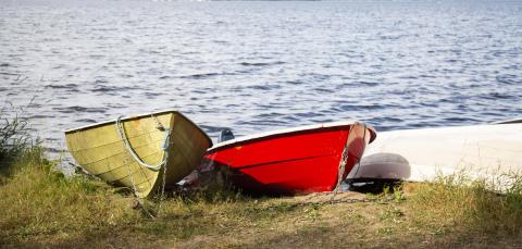 Ywllow and red boat on the beach.