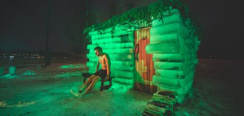 Man relaxing outside ice sauna in Rauhaniemi at city of Tampere, the international sauna capital of the world