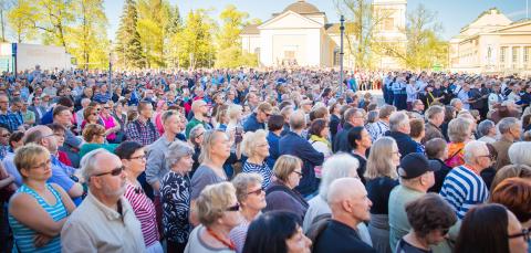 A large group of people at Keskustori (Central Square), observing a cultural event.