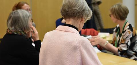 Henkilöt opiskelevat ja keskustelevat luokkatilassa.