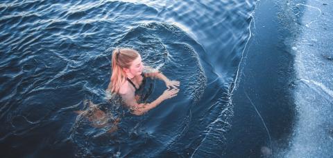 A girl swimming in ice-cold water.