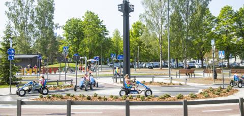 Children driving pedal cars in Children’s traffic park.