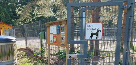 Dog park gate and signposts.