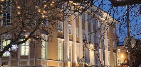 A large yellow building in dim winter lighting.