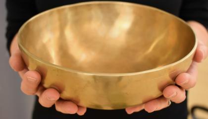 Kädet pitelevät äänimaljaa.