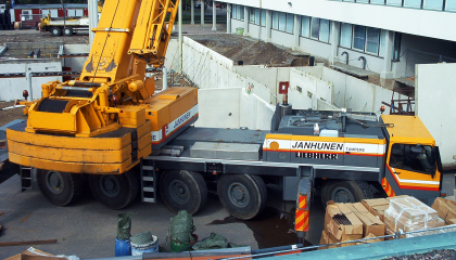 Kaivinkone ja kuorma-auto rakennustyömaalla.
