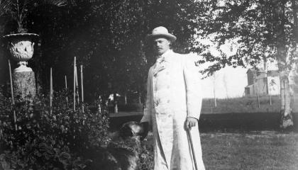 A man and a dog out in the park.
