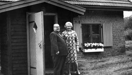 The couple is standing in front of the Haihara Chicken House.