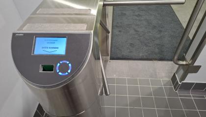 Swimming pool gate on the way out. A one-time wristband is inserted at the gate. A seasonal wristband is read with a reader.