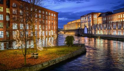Tammerkoski rapids illuminated and the light horses of Konsulinsaari Island at the dusk.