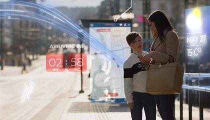 A boy and a woman holding a mobile phone in the street. Embedded in the image are various graphic elements related to digital development.