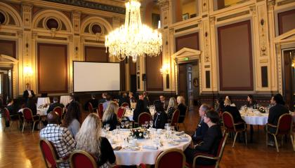 People seated at lunch tables inside Tampere City Hall.
