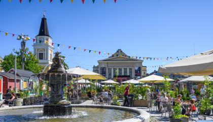 Tampereen keskustorilla järjestetty kesätori, jossa on katettuja terassipöytiä.