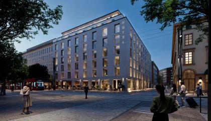 Kuvassa uusi rakennus iltavalaistuksessa. 