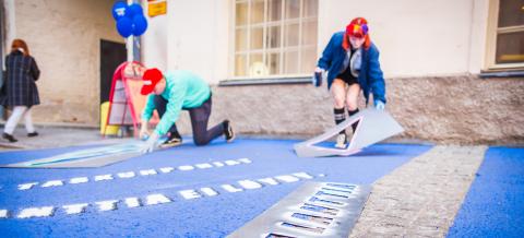 Two people painting the street.