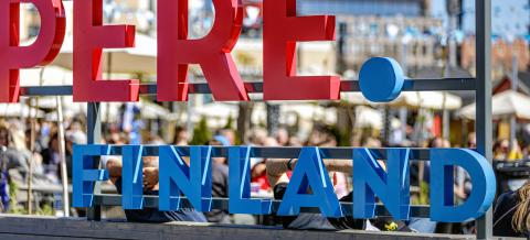 Kesäkeidas Summer Terrace restaurants photographed through a colourful Tampere.Finland sign.