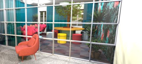 The lobby and conference area is full of different coloured furniture: small tables, chairs and a sofa. There is a glass wall in the middle of the room.