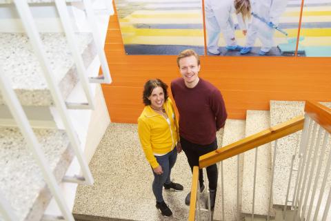 Kaksi aikuista seisovat rappussa.