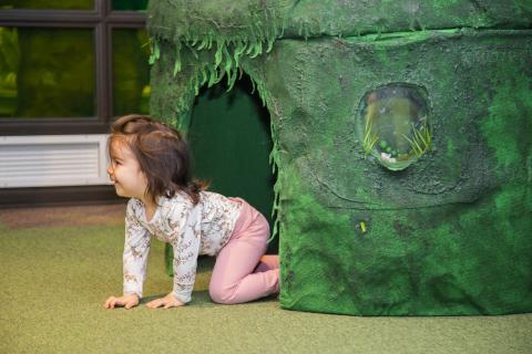 Child crawls out from the nest of mole.